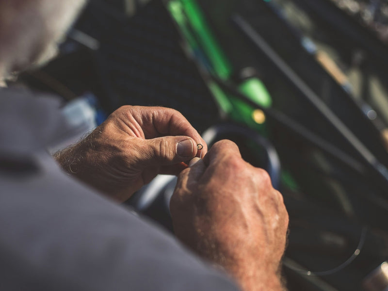 A man tying on a fluorocarbon tippet