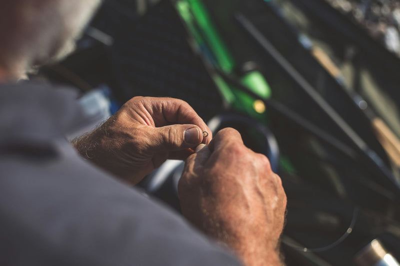 A man tying on a fluorocarbon tippet