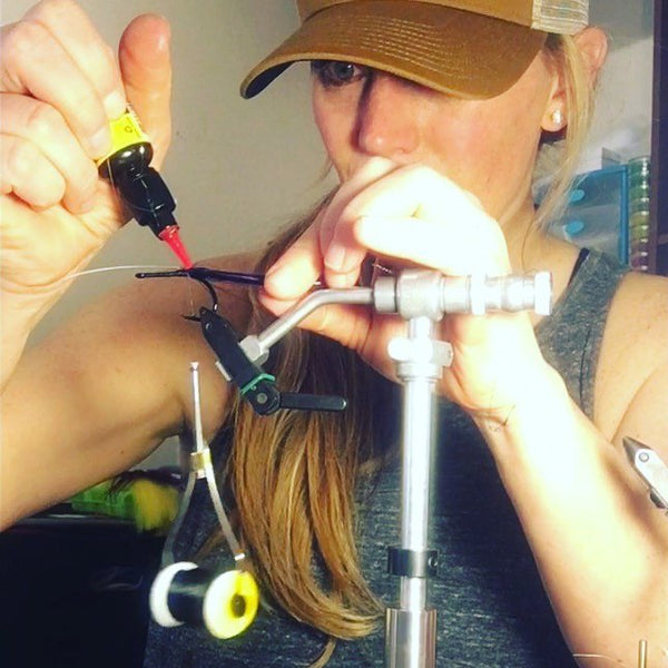 Young Woman using glue for fly tying
