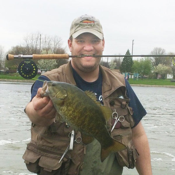 Fisherman with fishing pole and small fish